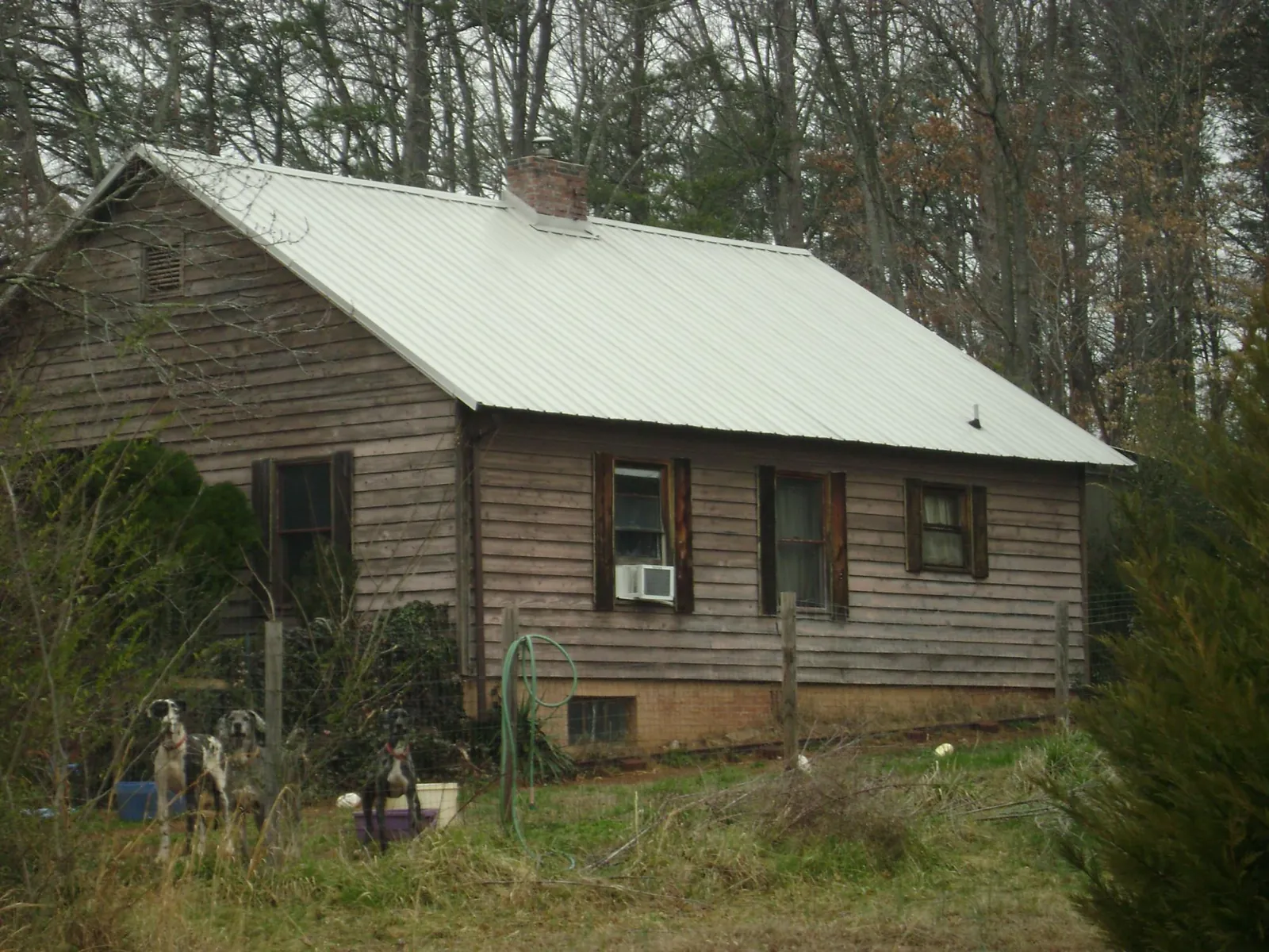 White metal roof on an old wood sided farmhouse, from a Metal Roof Installation job in Rachel